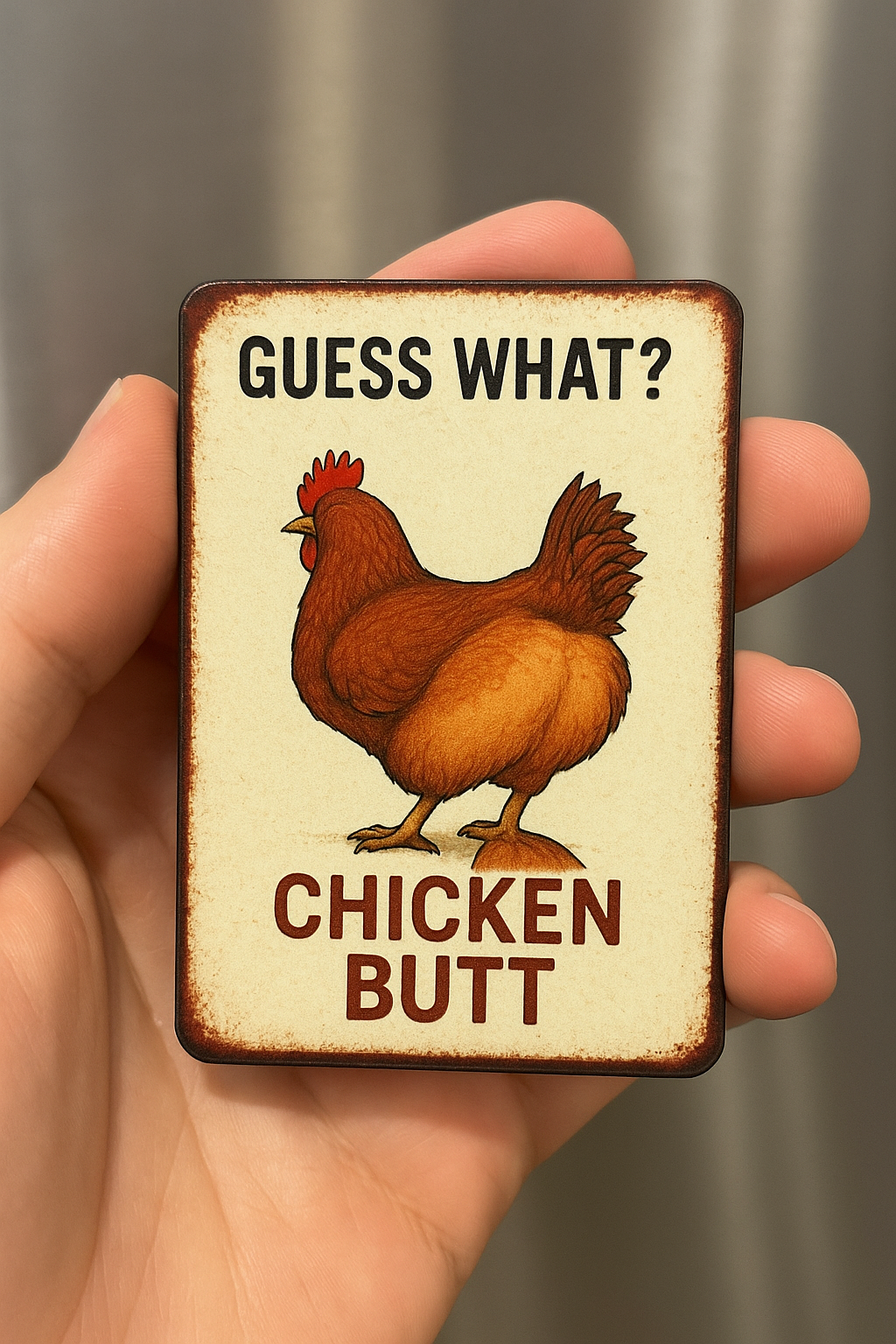 a hand holding a sign that says guess what? chicken butt