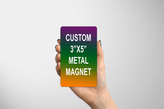 a hand holding a magnet that says custom 3x5 metal magnet