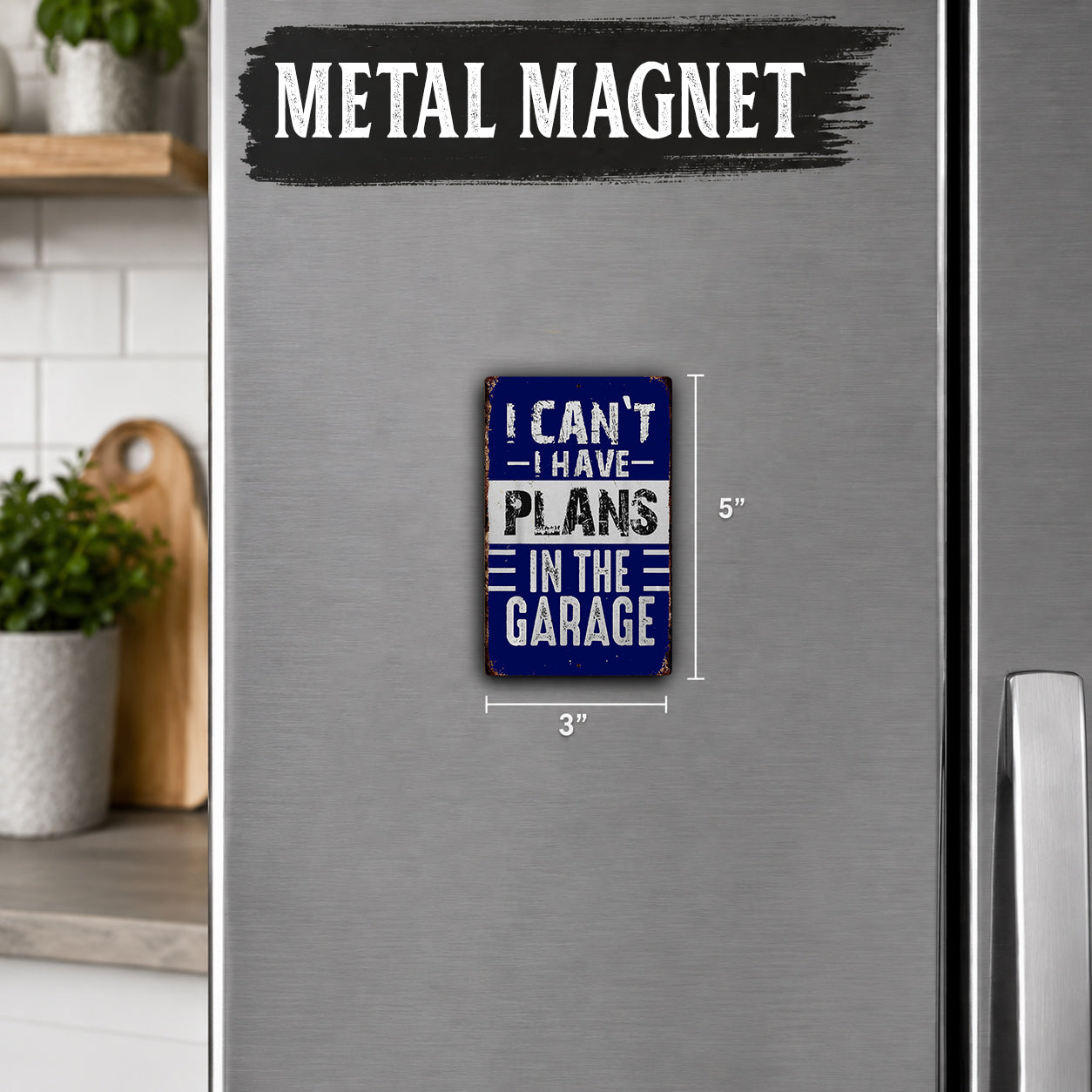 a small blue and white metal magnet with the text "I CAN'T HAVE PLANS IN THE GARAGE" on it.