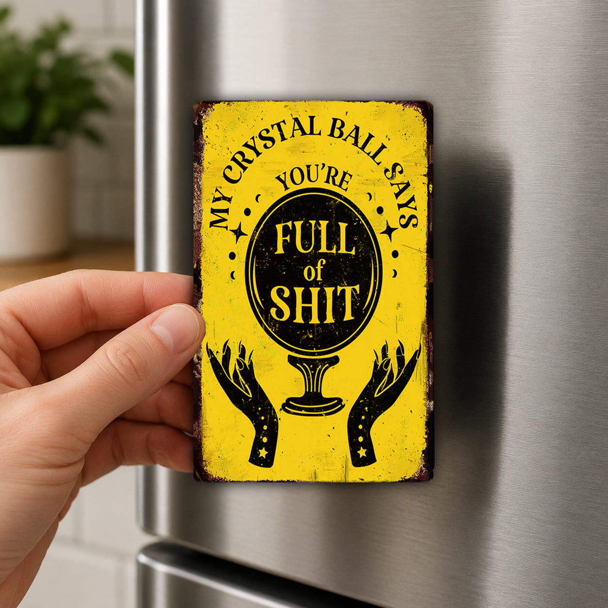 A person's hand is holding a yellow sign with a humorous text and graphic design.