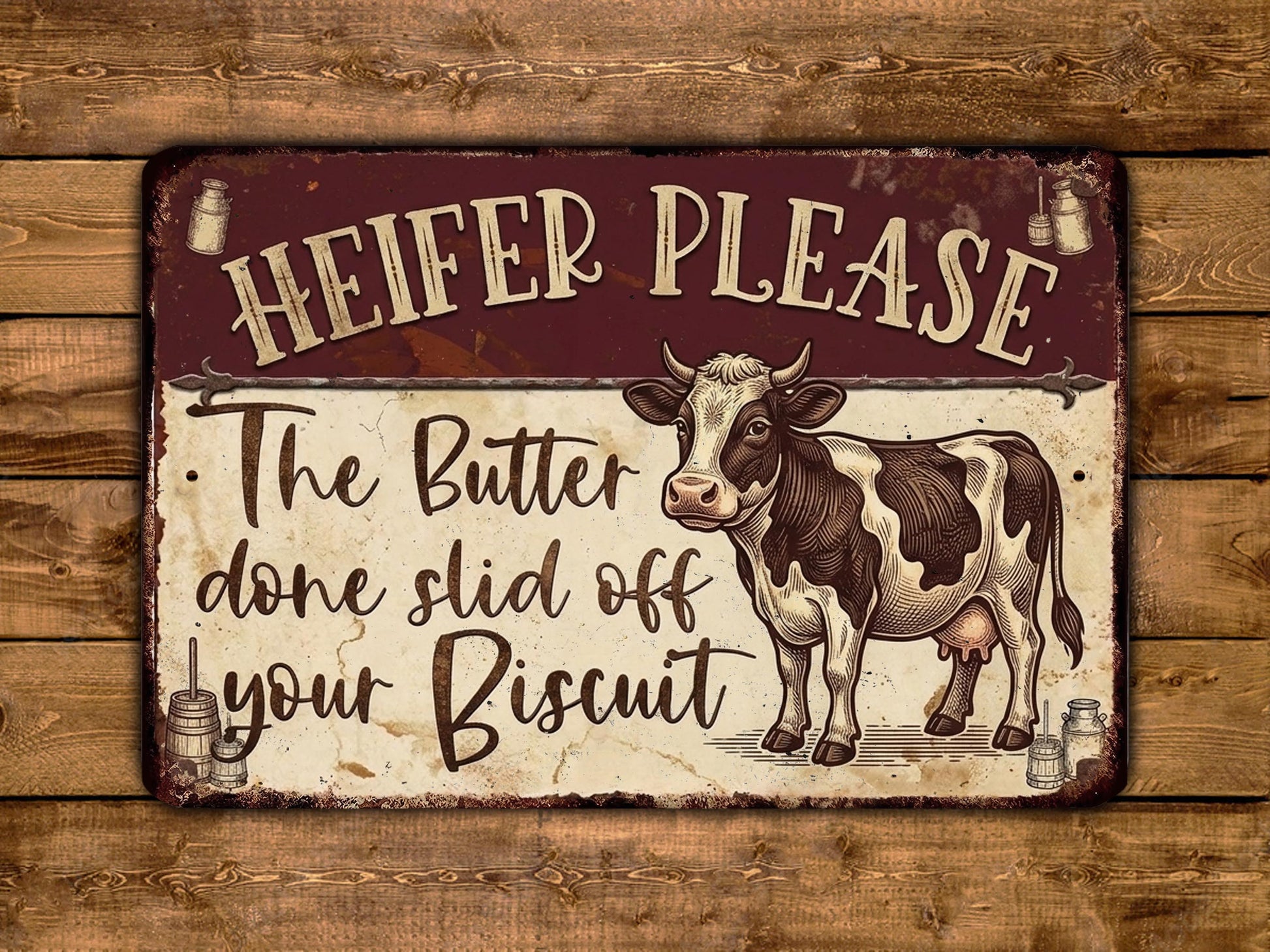 a sign with a cow illustration and text that reads "HEIFER PLEASE" and "The Butter done slide off your Biscuit".