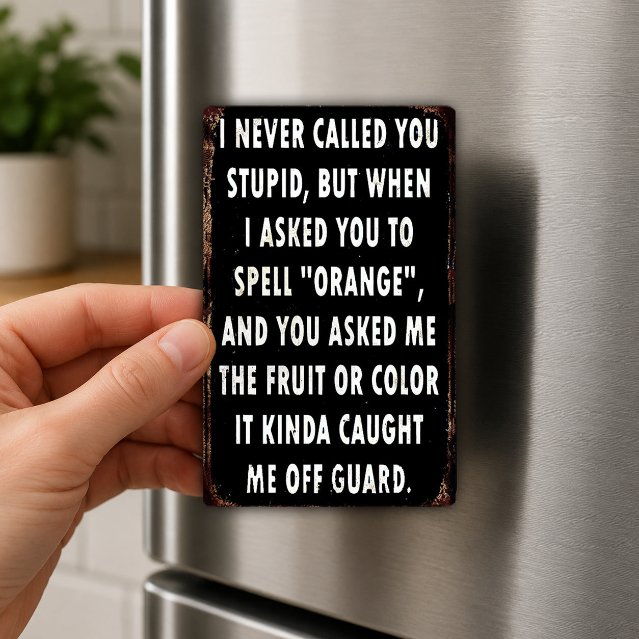 A person's hand holding a sign with a humorous message on it.