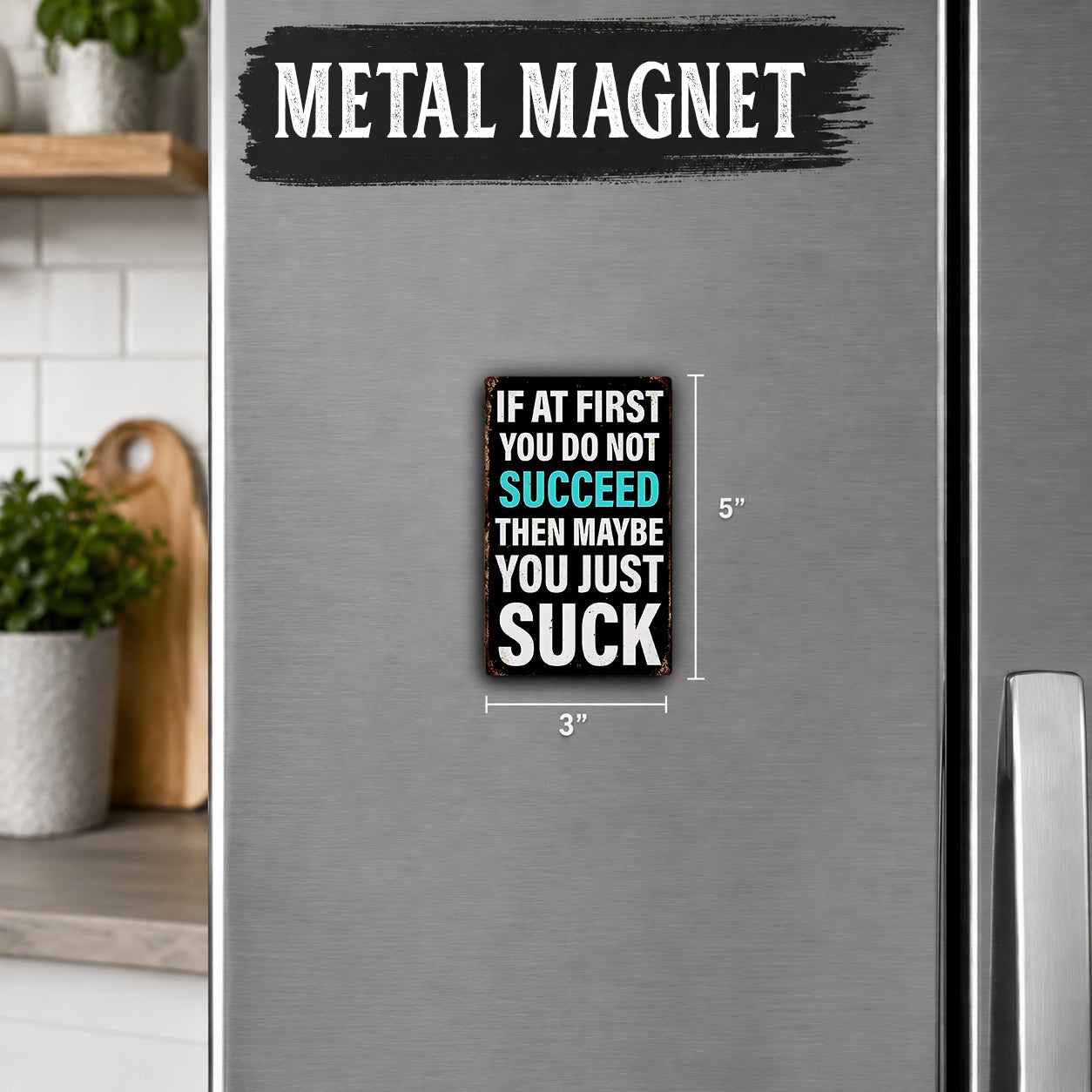 a refrigerator with a metal magnet on it. The magnet contains a humorous message that reads, "If at first you do not succeed then maybe you just suck".