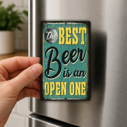 A hand is holding a magnet with the text "The BEST Beer is an OPEN ONE" on it.