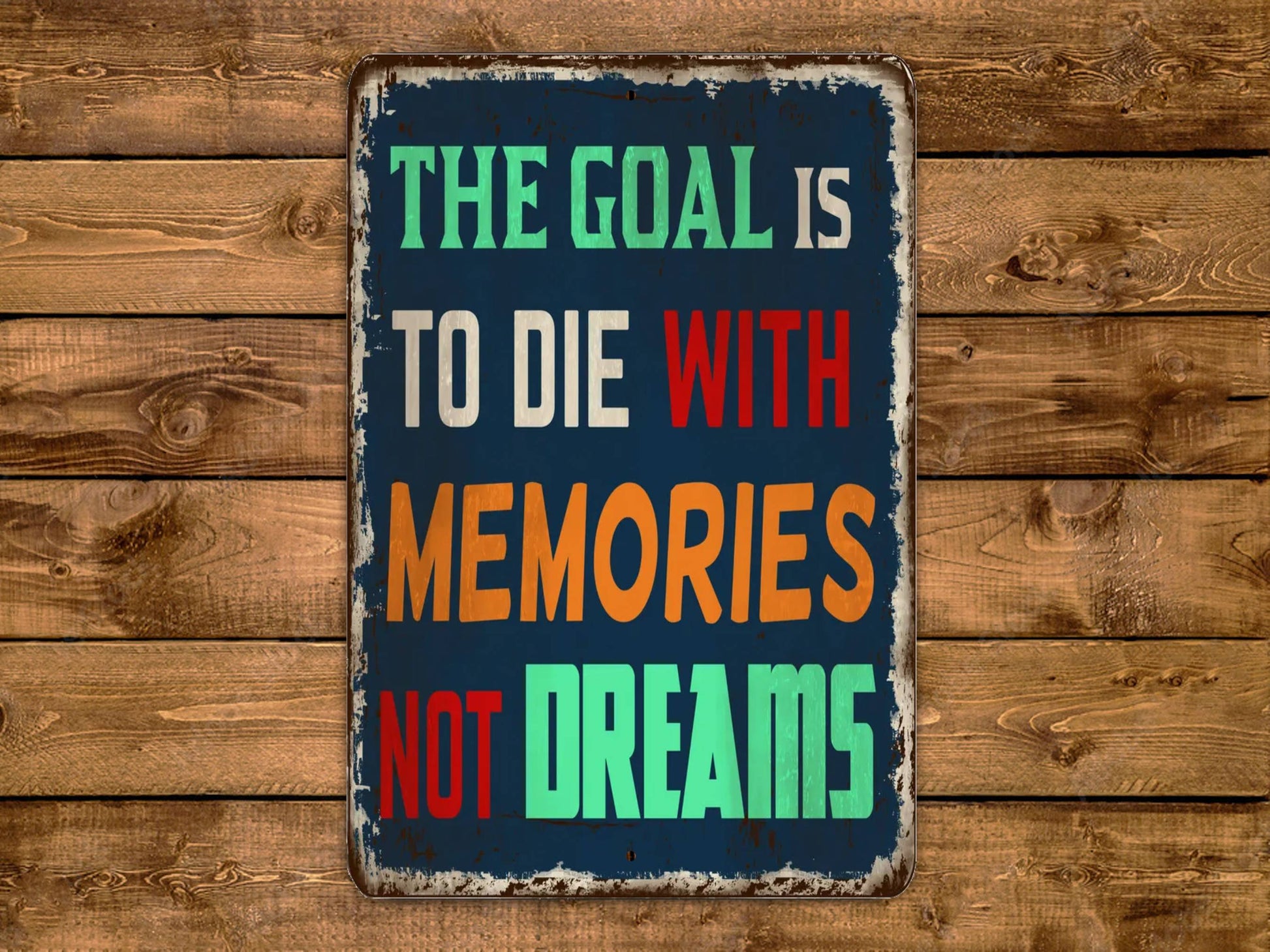 a sign that says the goal is to die with memories not dreams