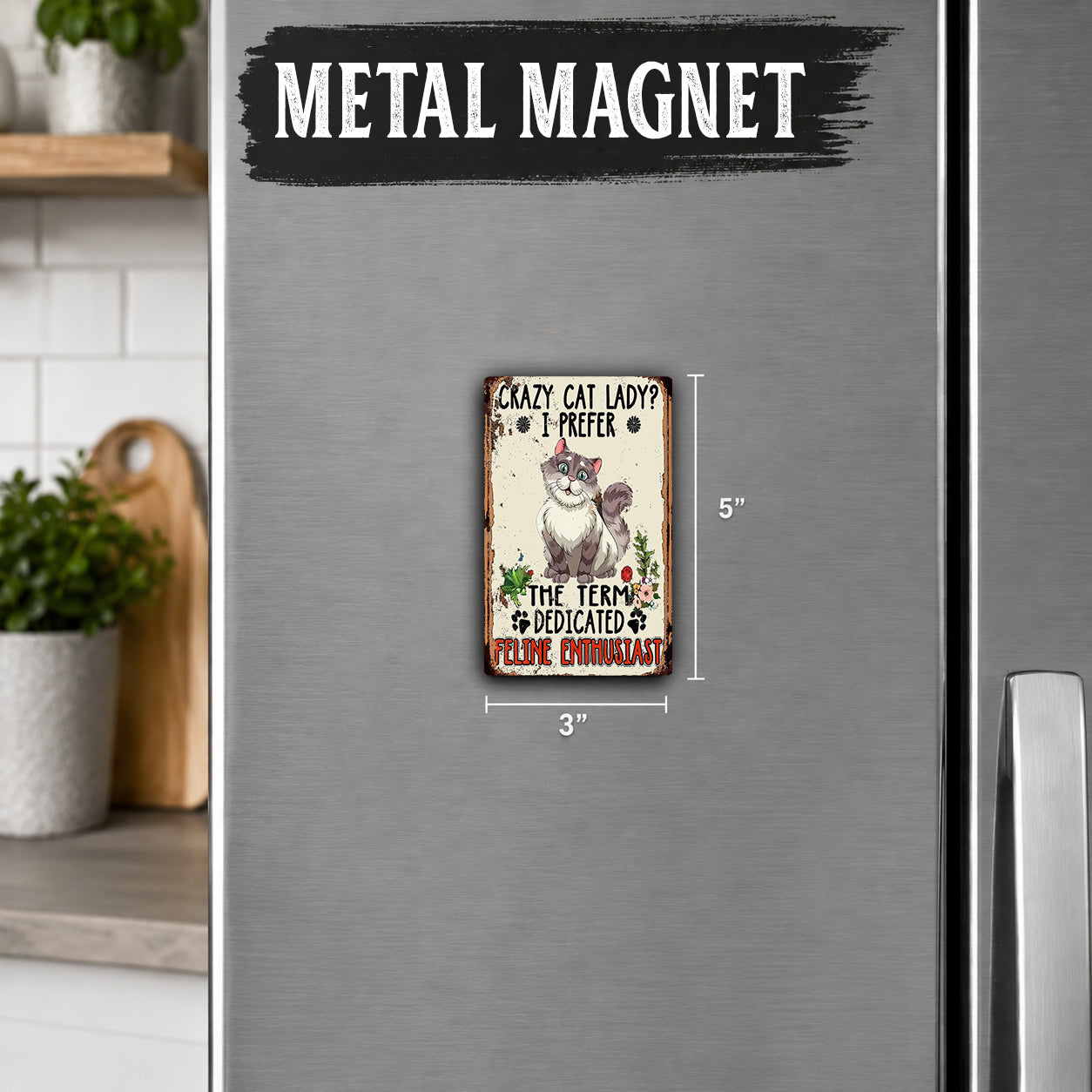 a small metal magnet with a cat illustration and text on it.