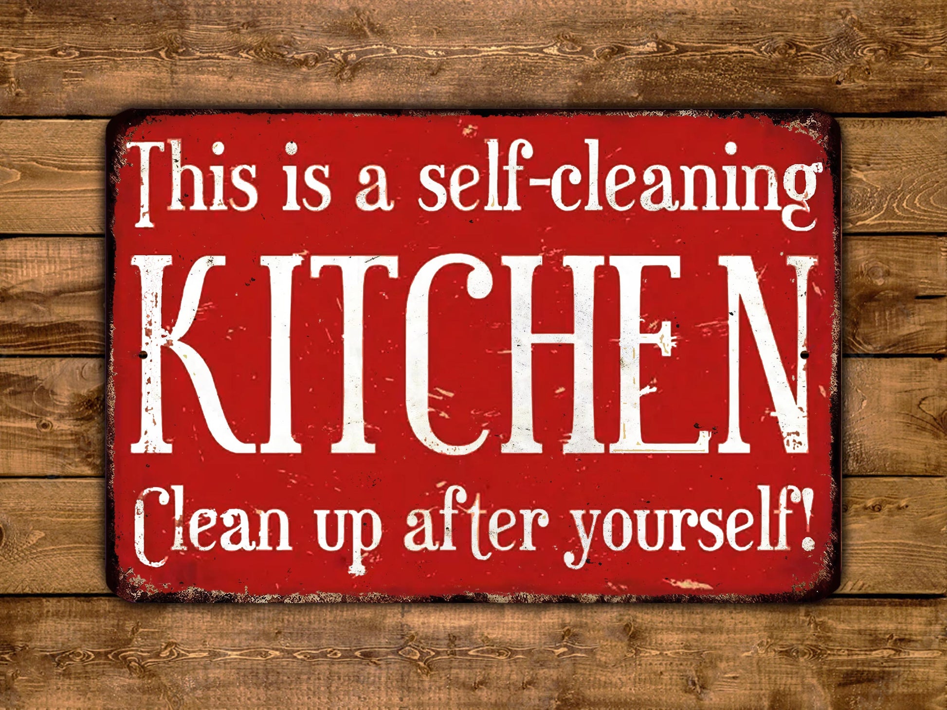 The image is a red sign with white text that reads "This is a self-cleaning KITCHEN Clean up after yourself!"