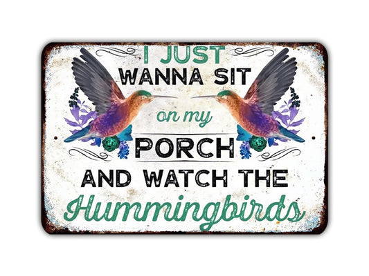 a metal sign that says i just wanna sit on my porch and watch the humming