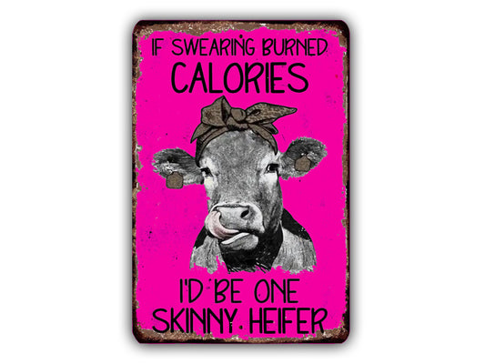 a cow with a pink background and a humorous caption that reads "If burning calories, I'd be one skinny. Heifer".