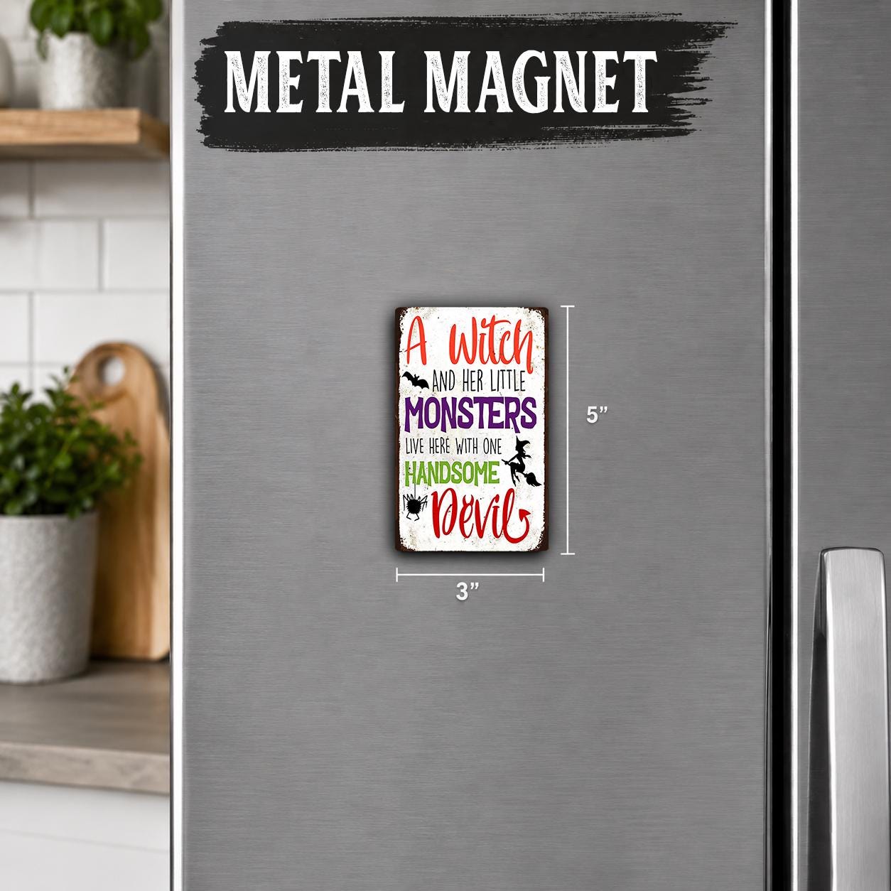 A small, colorful metal magnet with text on it is attached to the side of a refrigerator.