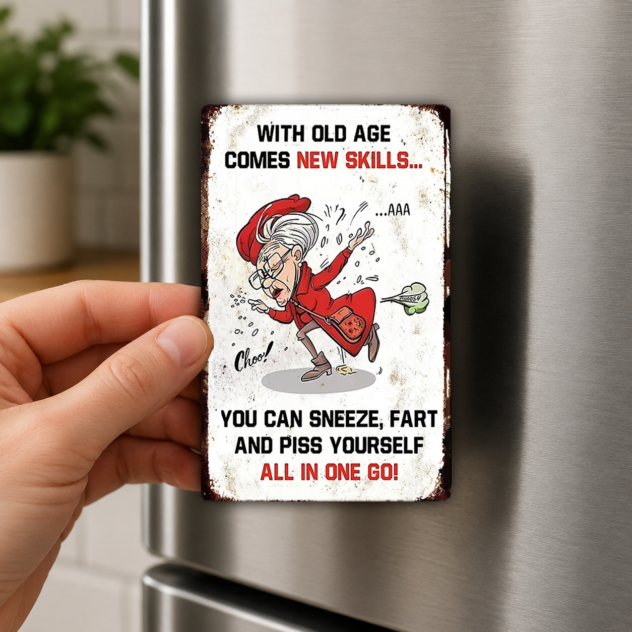 a humorous sign with a cartoon character, a hand holding the sign, and a refrigerator in the background.