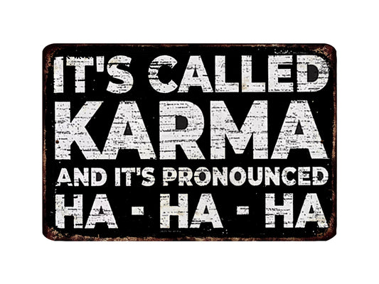 a sign with the text "It's called Karma and it's pronounced Ha-ha-ha" in a distressed, distressed font.