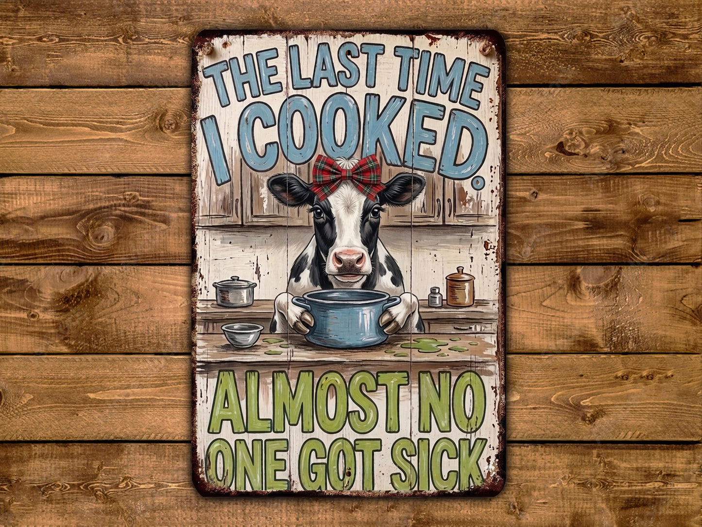 a cow sitting at a kitchen counter, holding a pot, and surrounded by various kitchen items. The text above the cow reads "THE LAST TIME I COOKED ALMOST NO ONE GOT SICK".