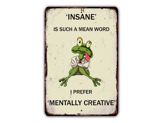 a metal sign with a picture of a frog saying, insane is such a