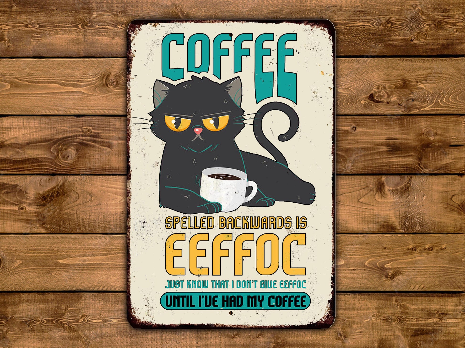 The image is a humorous sign featuring a black cat with a coffee cup, accompanied by the text "COFFEE SPELLED BACKWARDS IS EEFOC" and "Just know that I don't give effee".