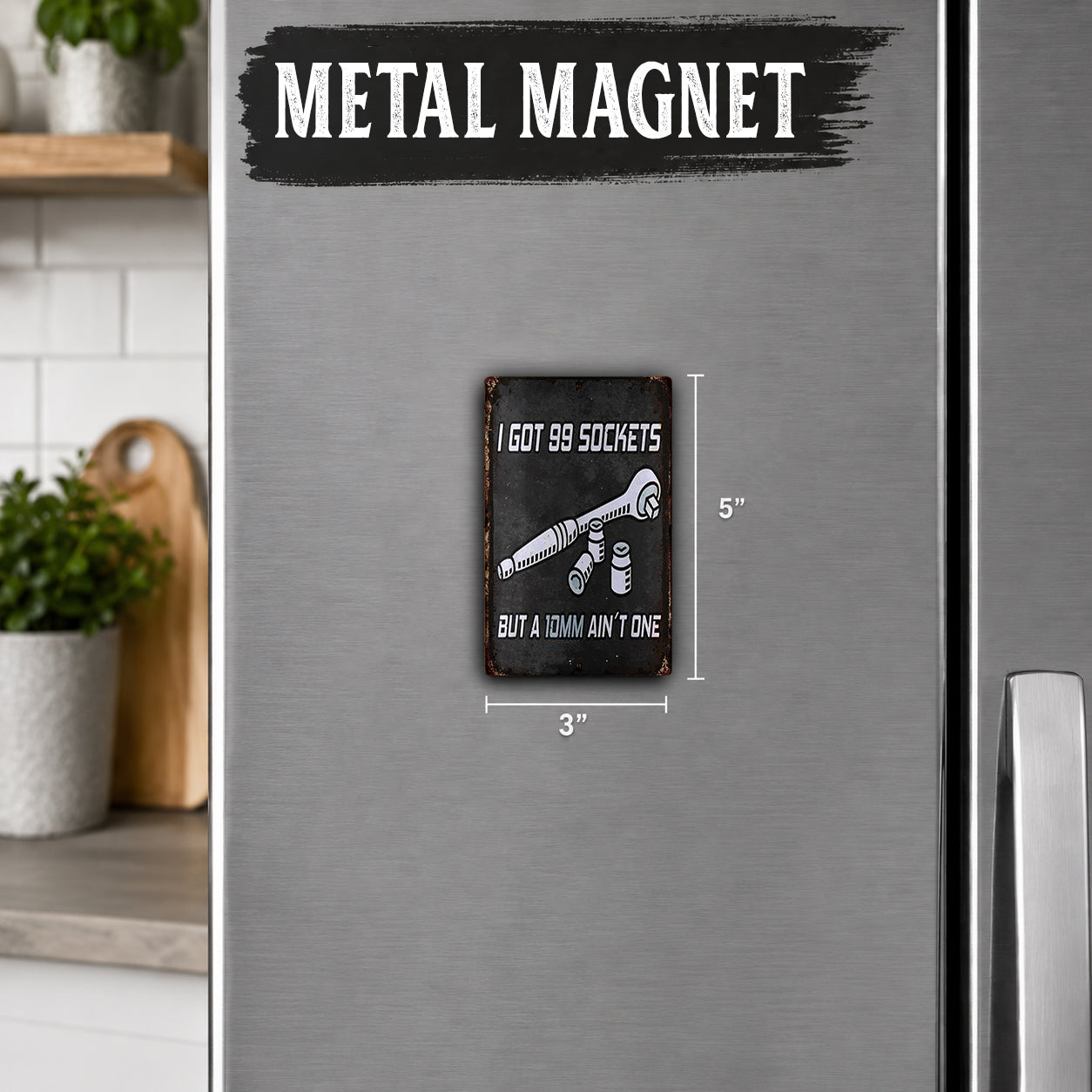 a metallic refrigerator magnet with the text "I got 99 sockets but a wrench ain't one" and dimensions of 3 inches.