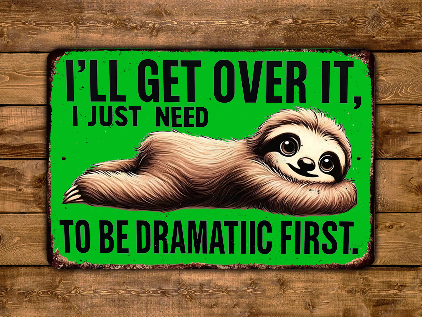 A humorous sign with a sloth lying on its back and the text "I'LL GET OVER IT, I JUST NEED TO BE DRAMATIC FIRST."