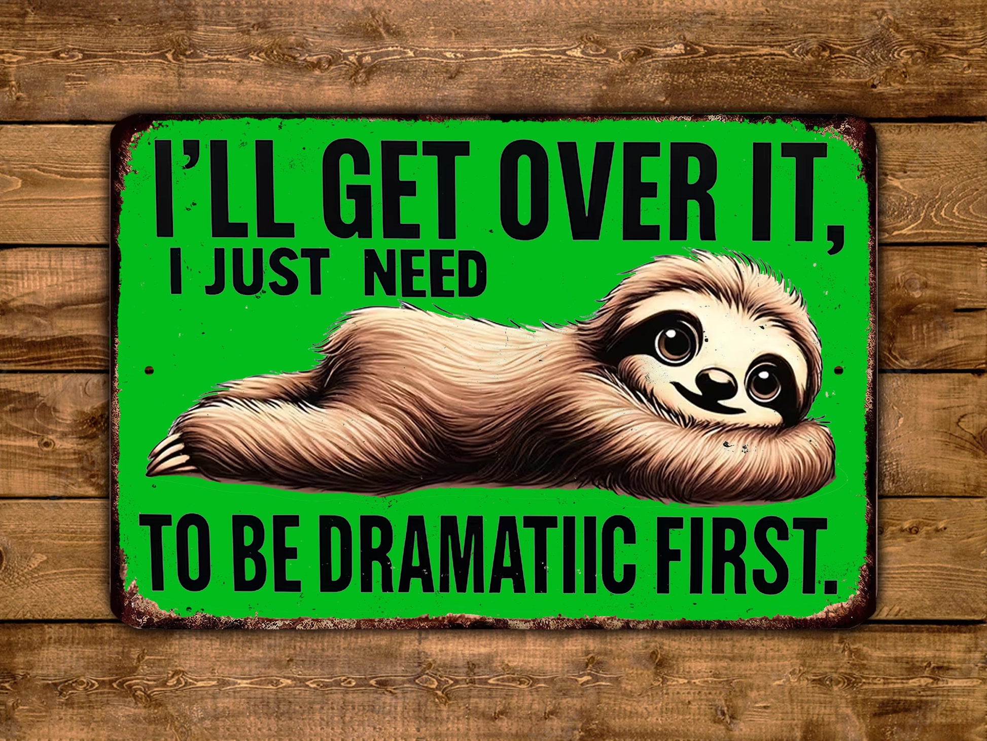 A humorous sign with a sloth lying on its back and the text "I'LL GET OVER IT, I JUST NEED TO BE DRAMATIC FIRST."