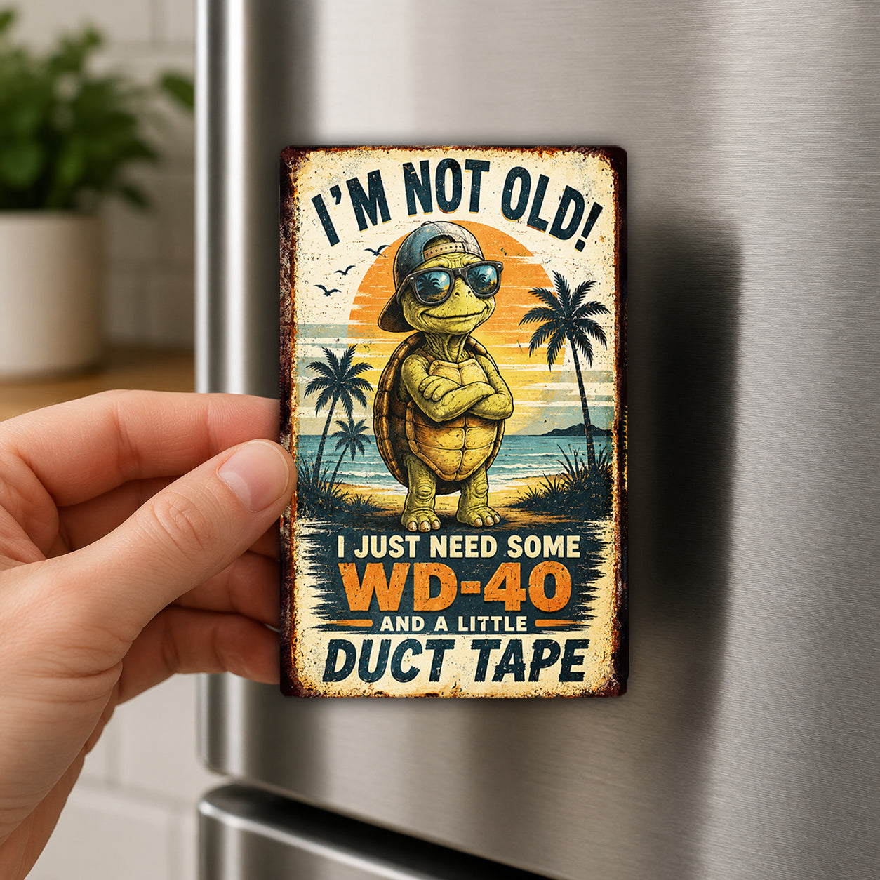 A person's hand is holding a vintage-style metal magnet with a cartoon turtle and a humorous text.