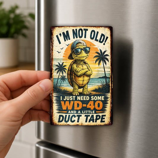 A person's hand is holding a vintage-style metal magnet with a cartoon turtle and a humorous text.