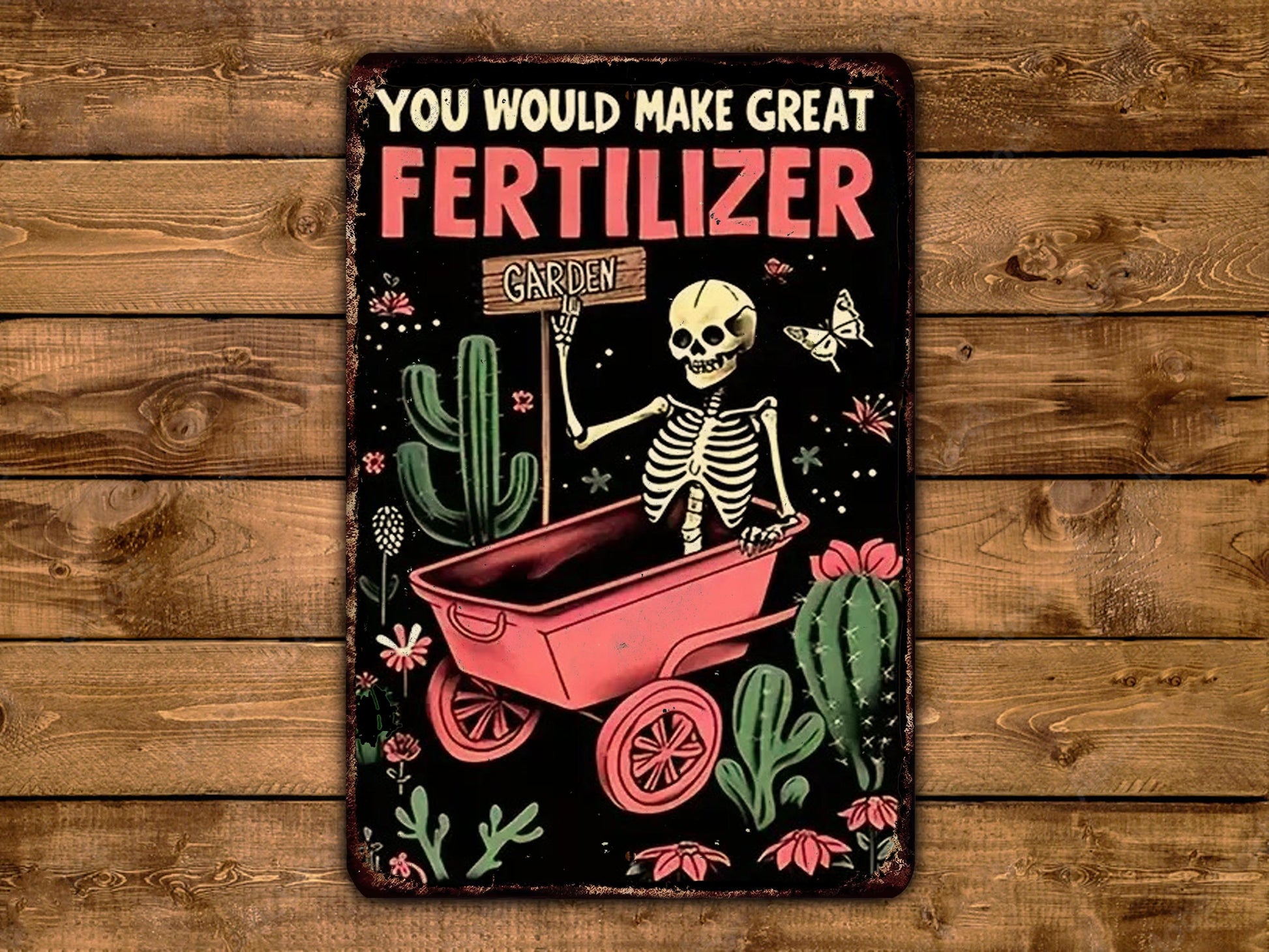 A vintage-style sign with a skeleton holding a sign that says "Garden" and a cactus, all set against a wooden background.