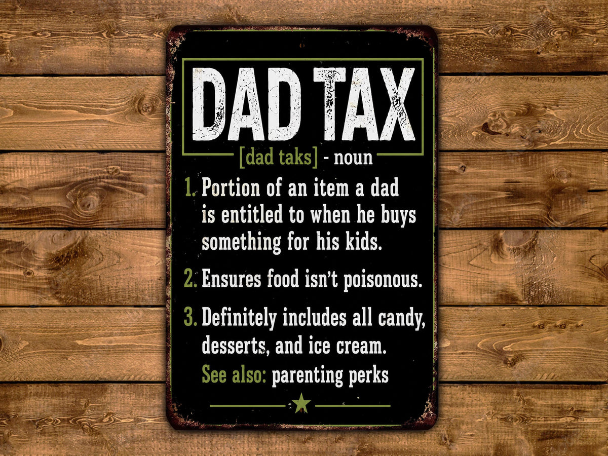 The image is a humorous sign that defines "dad tax" in a playful and exaggerated manner.