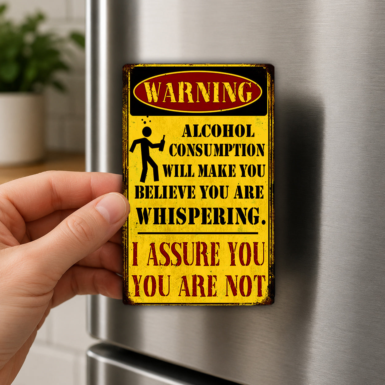 A person is holding a metal sign with a warning message about alcohol consumption.