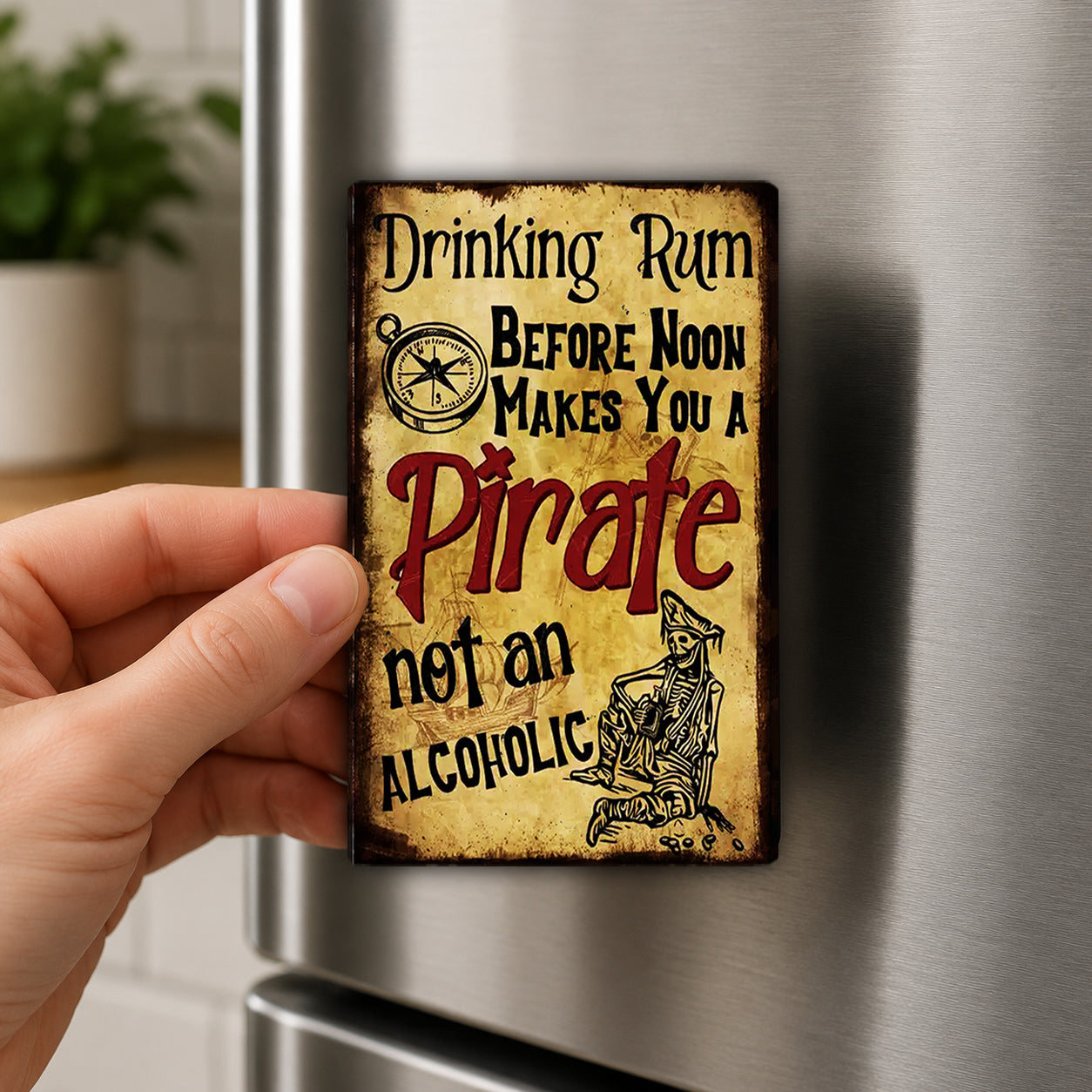 A person's hand is holding a small, vintage-style sign that reads "Drinking Rum Before Noon Makes You a Pirate Not an Alcoholic".