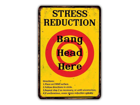 The image is a vintage-style sign with the text "Stress Reduction" and "Bag Head Here" in bold black letters. The sign also includes directions for reducing stress, such as placing the "Firm surface" on the left, following the " Directions" in the center, repeating the " Directions" in the right, and taking a "step 2 as necessary, or until unconscious" if the "Step 2" is not taken.