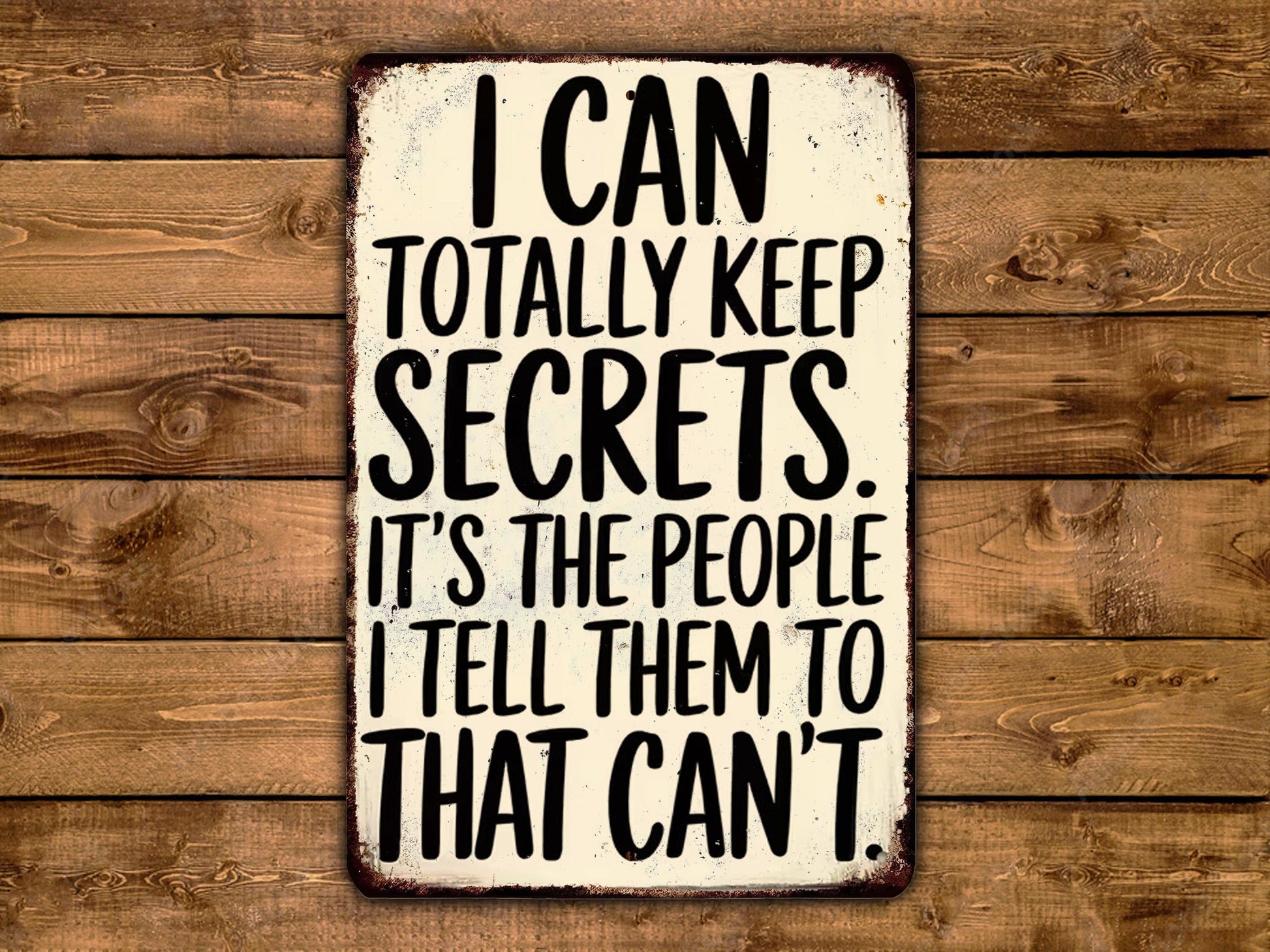 a sign with the text "I can totally keep secrets. It's the people I tell them to that can't" written on it.