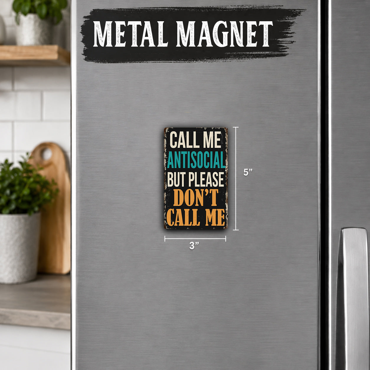 a small, vintage-style metal magnet with the text "Call me antisocial but please don't call me" on it.