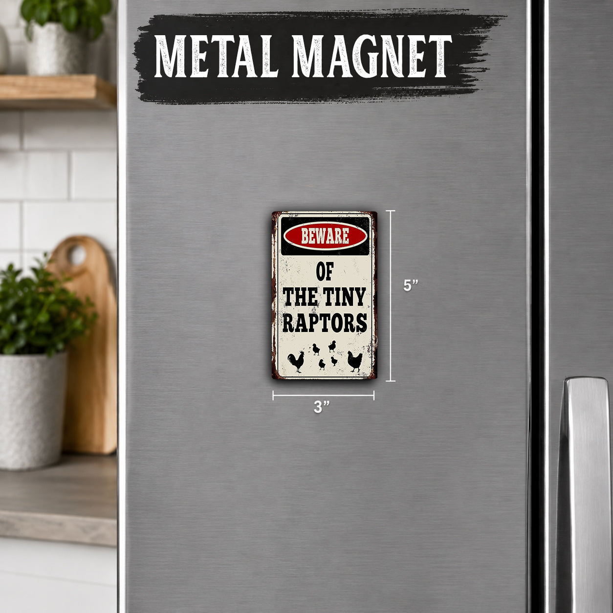 a small metal refrigerator magnet with the text "BEWARE OF THE TINY RAPTORS" and a warning symbol.