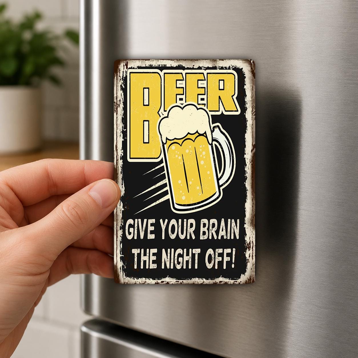 A hand is holding a metal sign with a beer mug and the text "BEER GIVE YOUR BRAIN THE NIGHT OFF!"