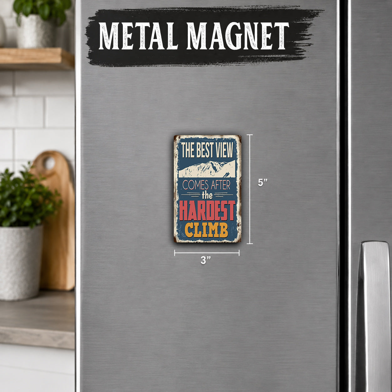 a small metal magnet with a quote about climbing, placed on a refrigerator.