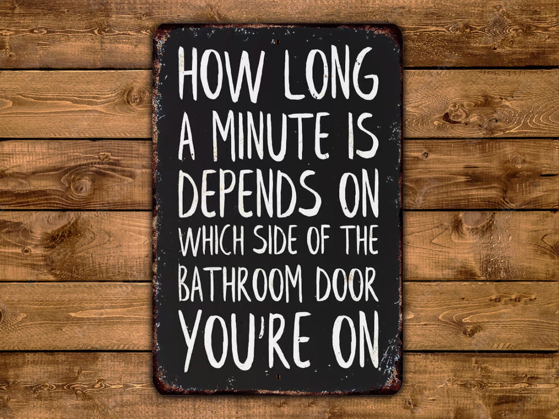 a sign with the text "How long a minute is depends on which side of the bathroom door you're on" written on it.