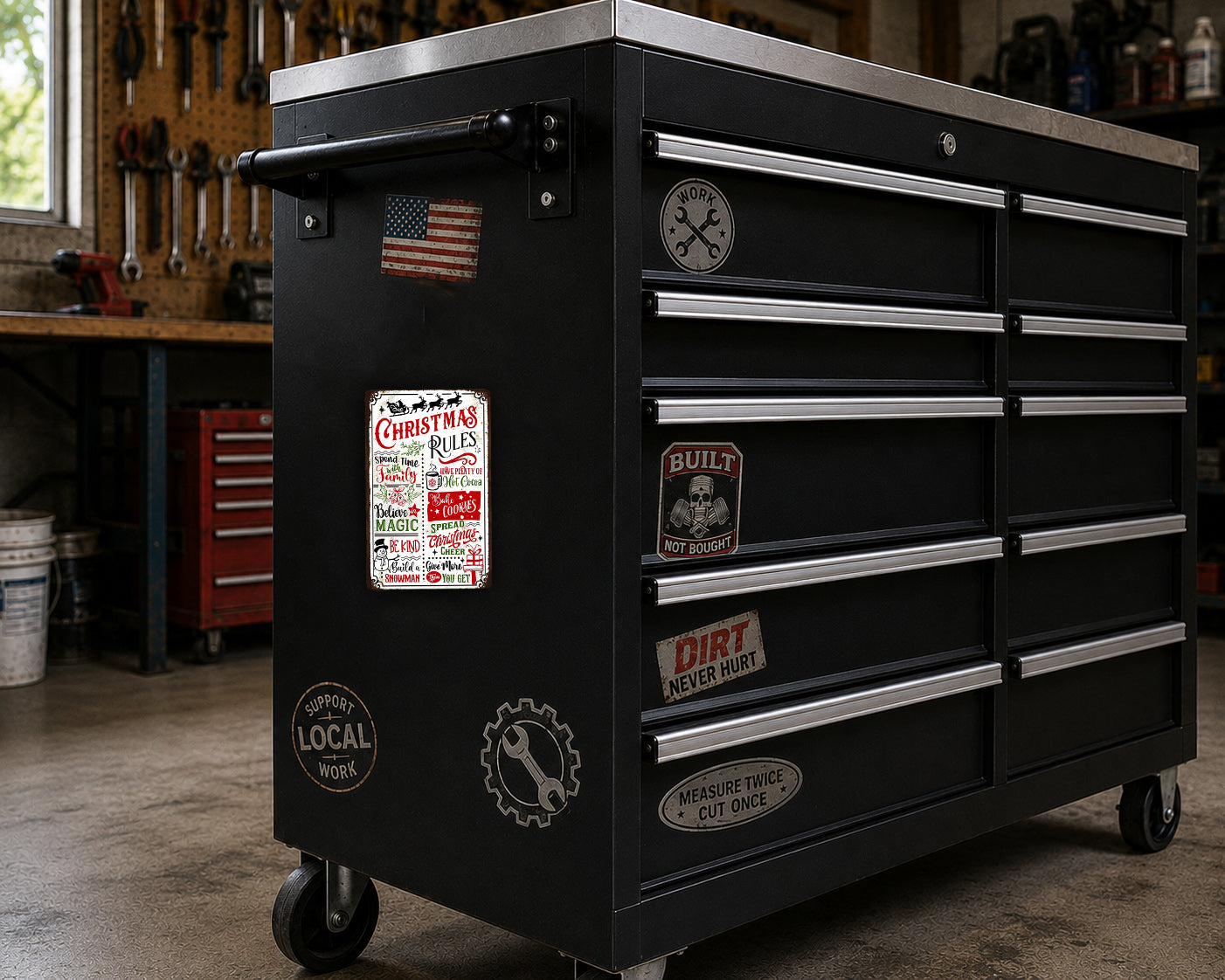 A black workbench with various stickers and labels on it, including a Christmas-themed sticker and a "BUILT" sticker.