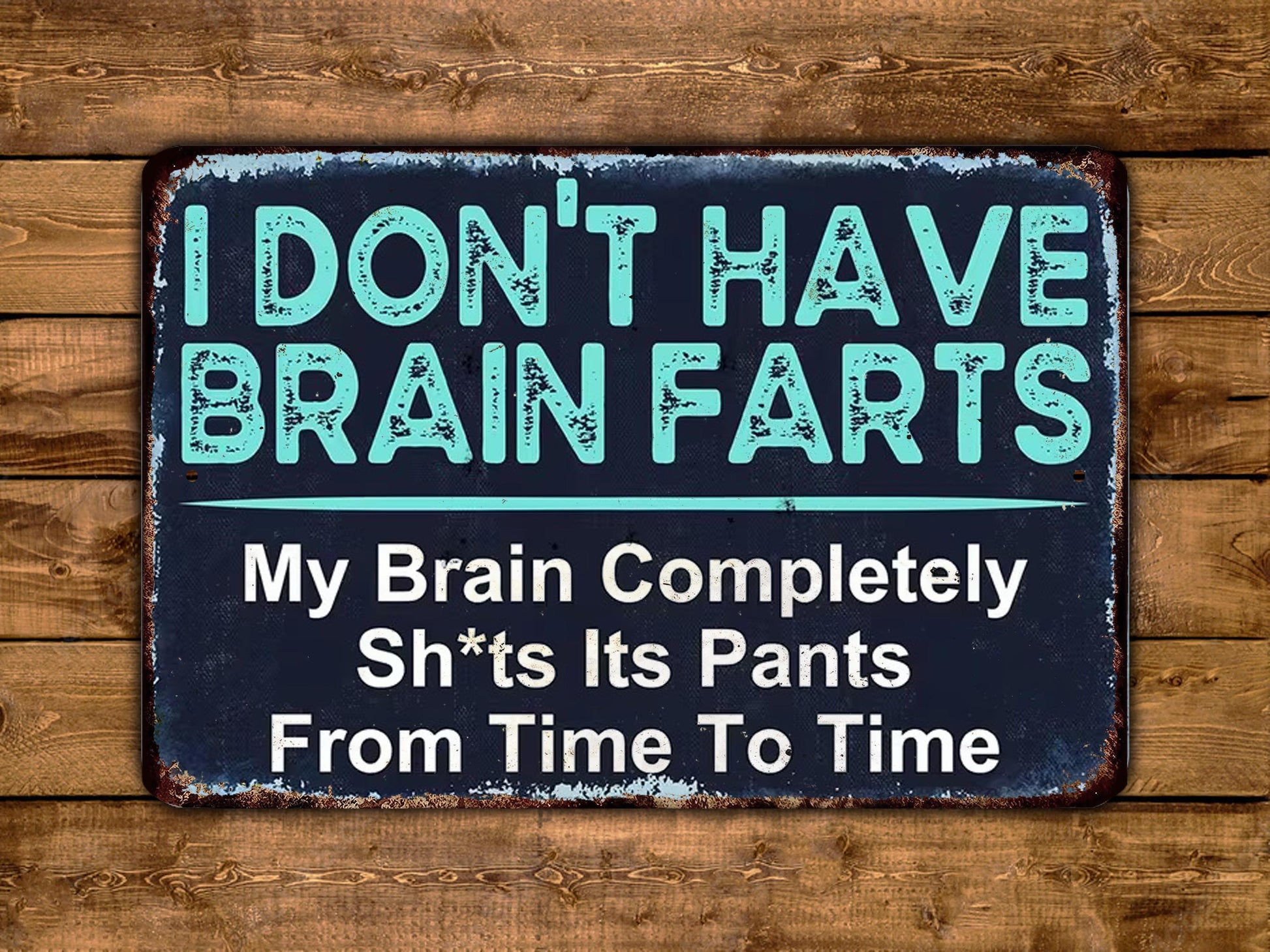 a humorous sign with the text "I DON'T HAVE BRAIN FARS" and "My Brain Completely Sh*t's Its Pants From Time To Time" against a wooden background.