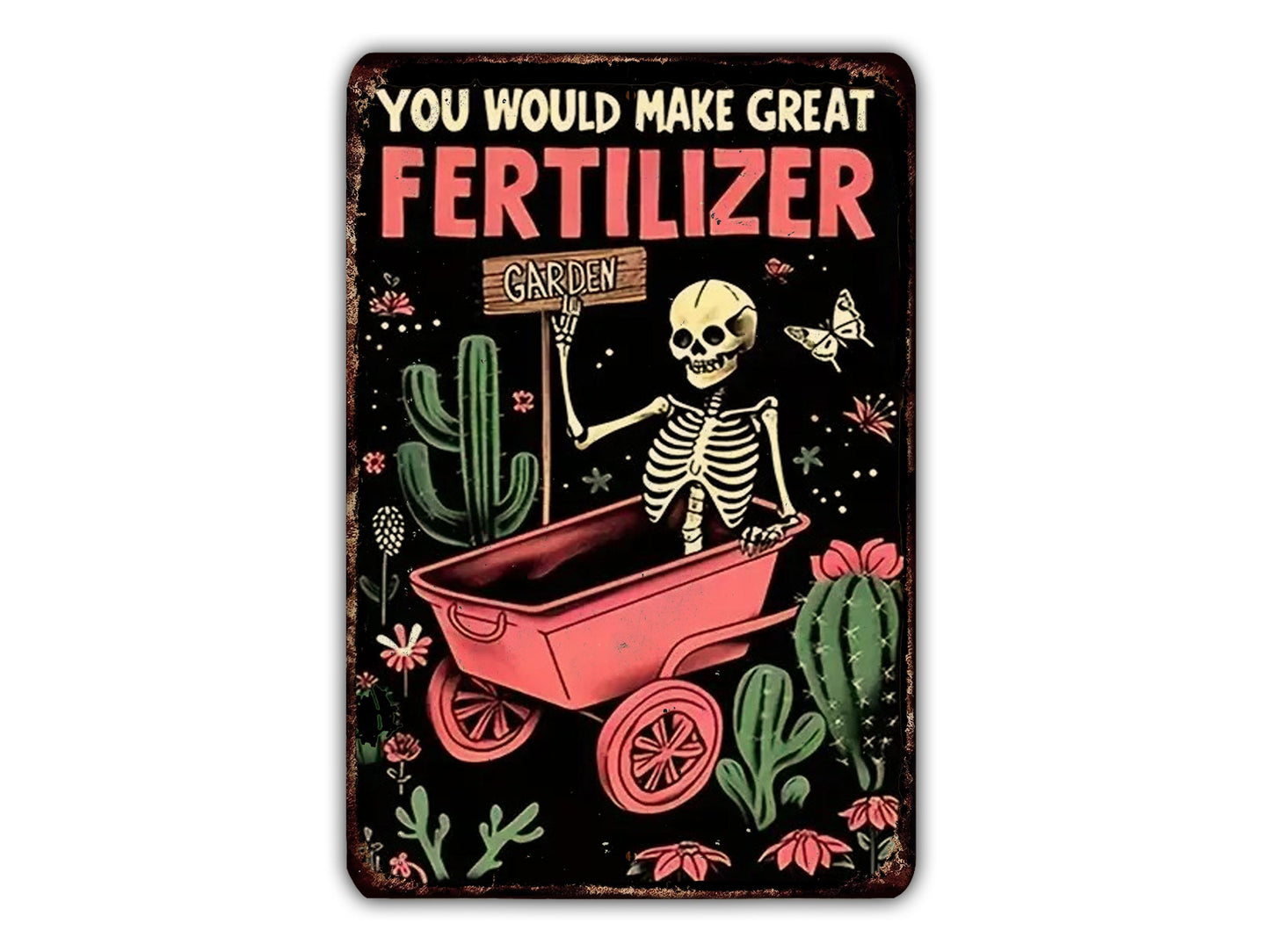 A skeleton holding a sign that says "Garden" while sitting in a red wheelbarrow surrounded by cacti, flowers, and butterflies.