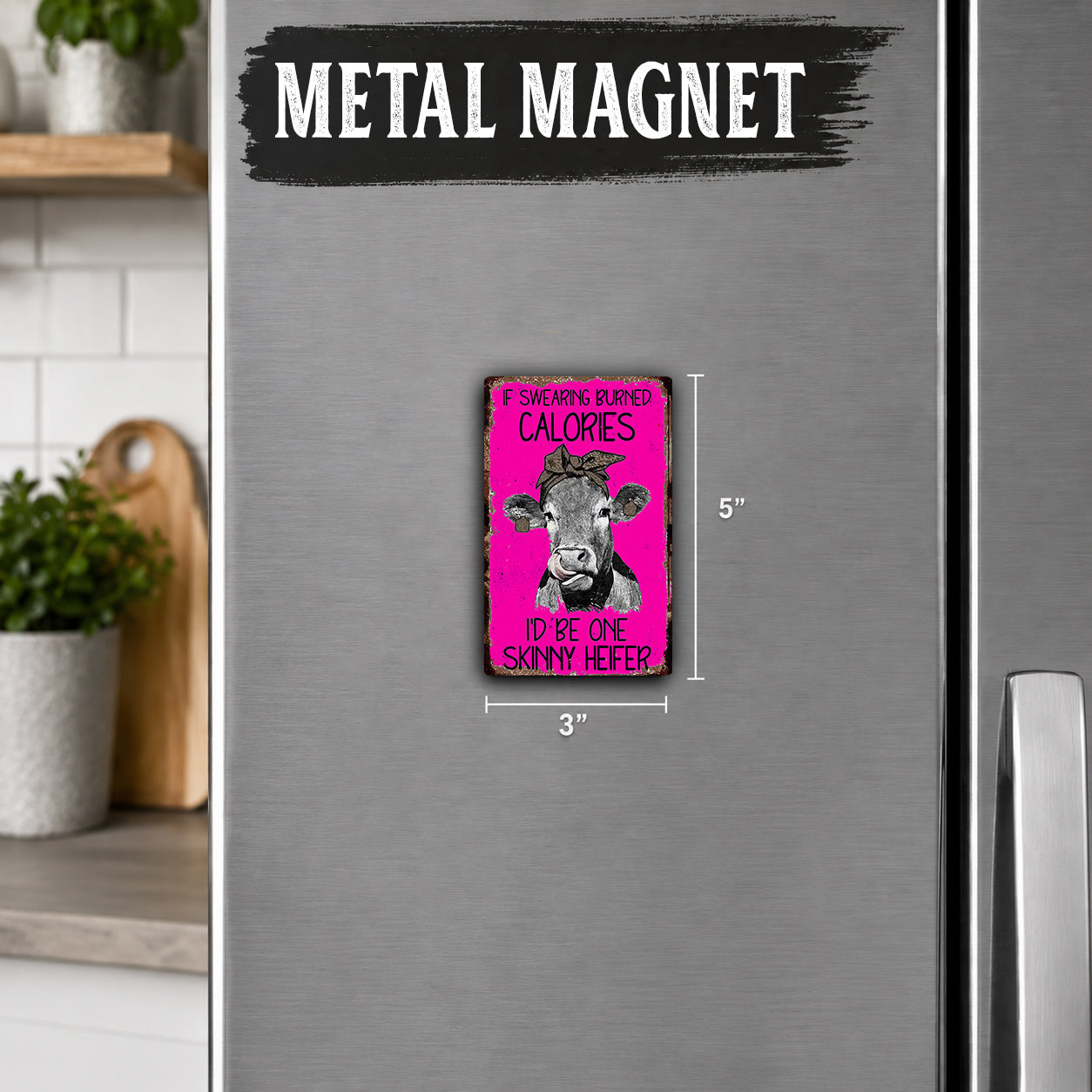 a pink and black magnet on a refrigerator, with the text "IF SWEATING BURNS CALORIES I'D BE ONE SKINNY HEIFER" printed on it.