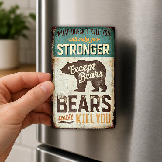 a person's hand holding a small, vintage-style magnet with a humorous message about bears.