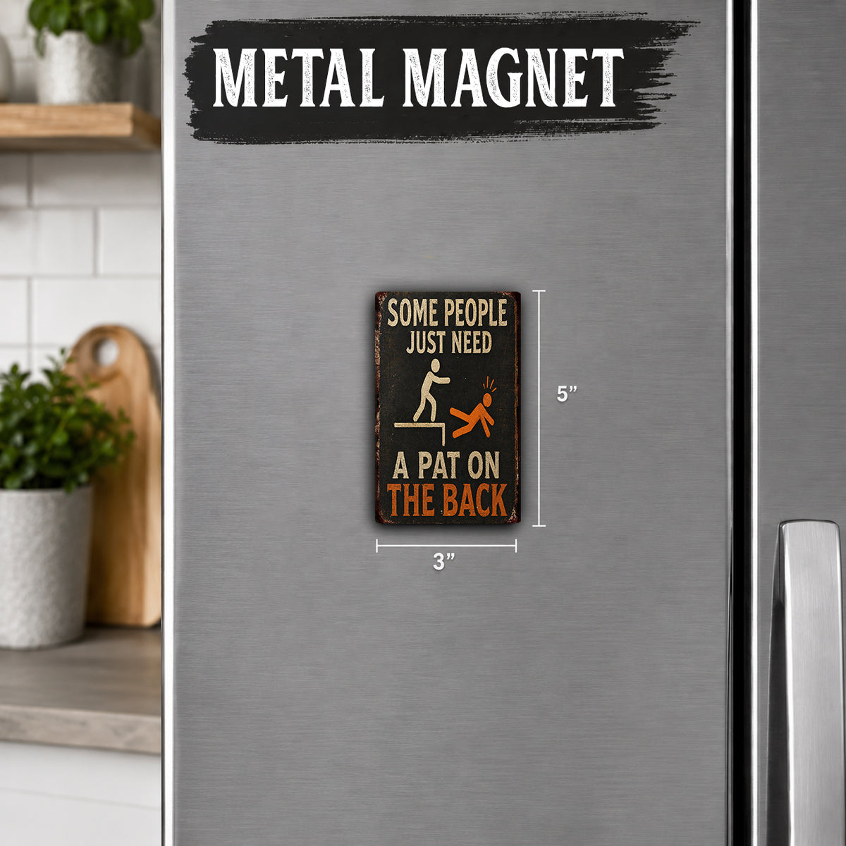 a small metal magnet with a humorous message on it, placed on a refrigerator.
