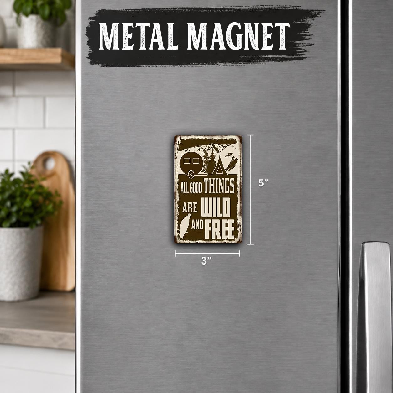 a small metal magnet with the text "All good things are wild and free" on it, placed on a refrigerator.