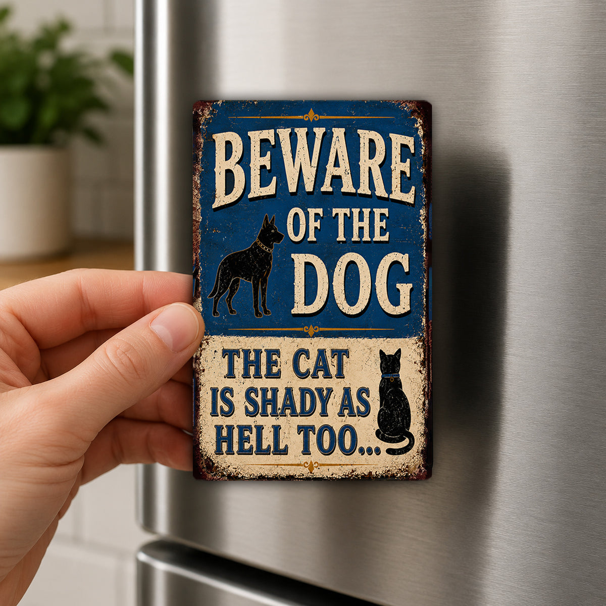 A person's hand is holding a metal sign with the text "BEWARE OF THE DOG THE CAT IS SHADY AS HELL TOO..."
