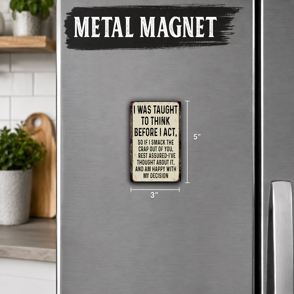 a small metal magnet with a humorous message on it, placed on a refrigerator.