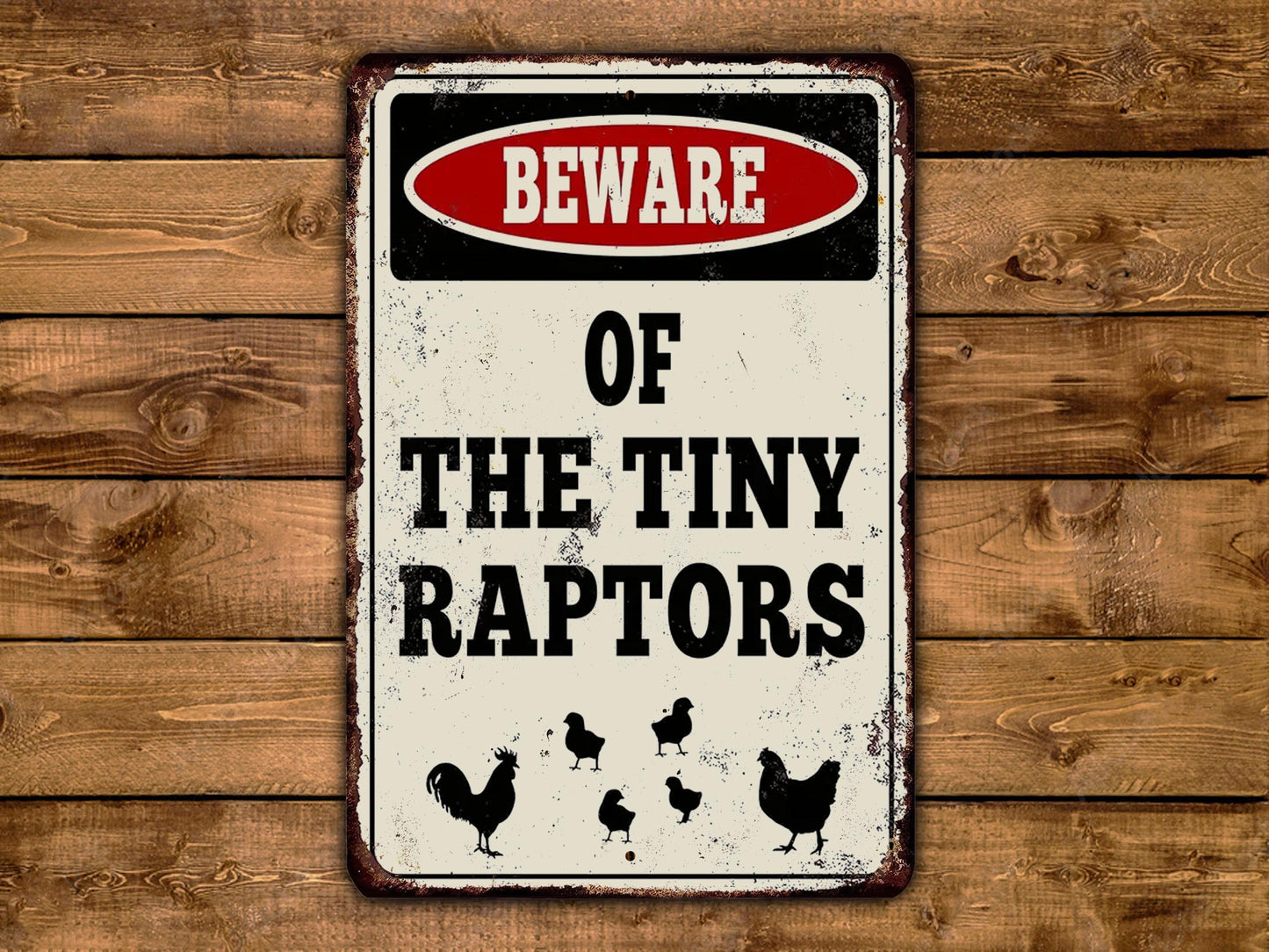 a sign on a wooden wall stating beware of the tiny raptors