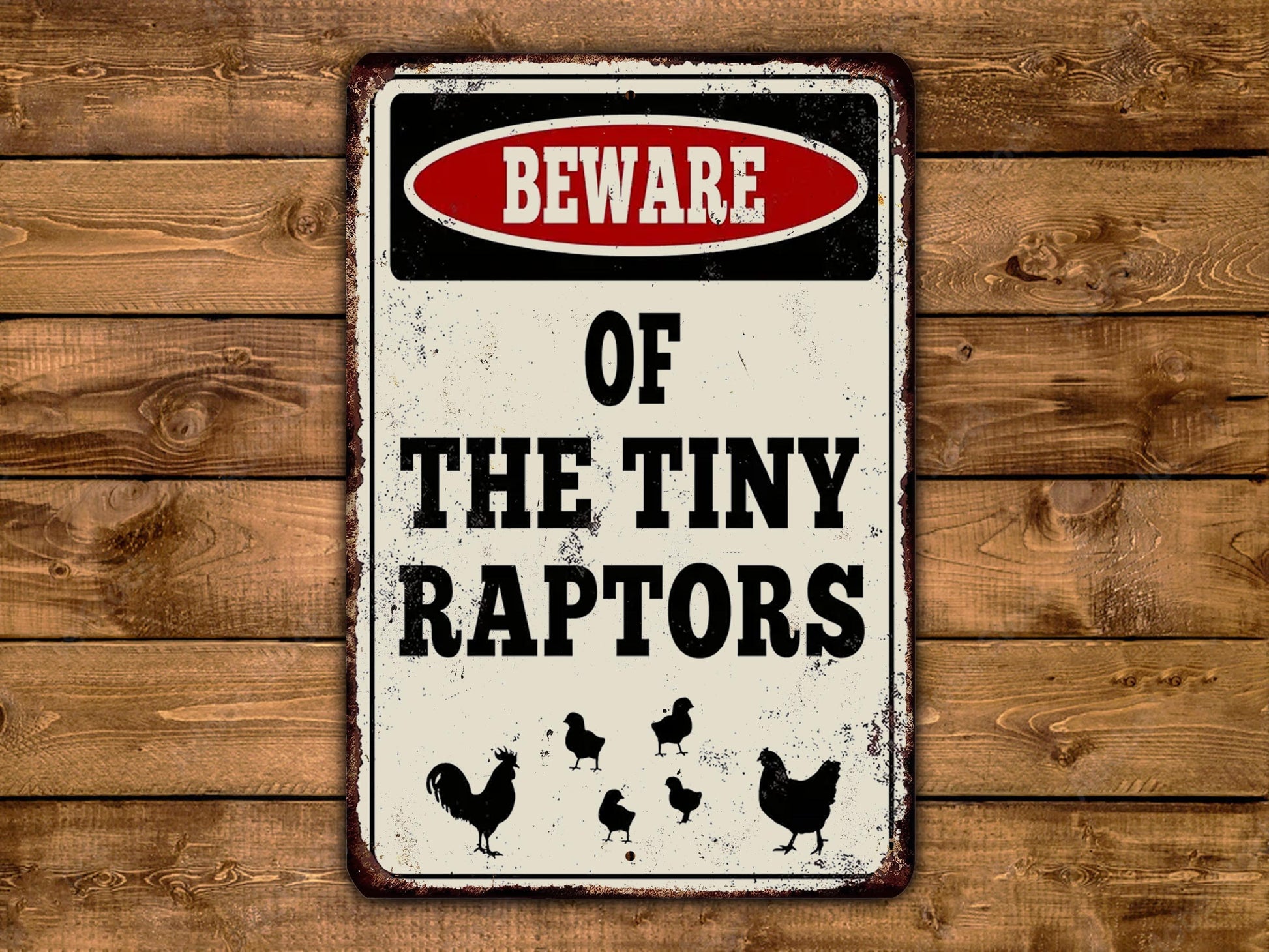 a sign on a wooden wall stating beware of the tiny raptors