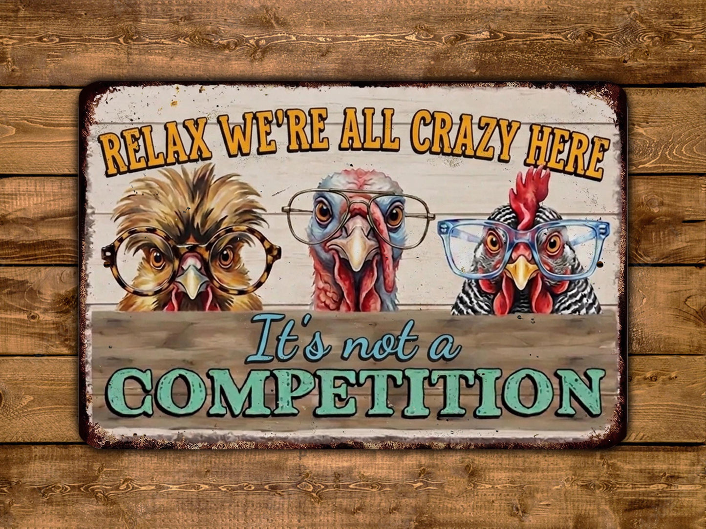 A vintage-style metal sign with a humorous message about chickens and their glasses, accompanied by the text "Relax, we're all crazy here" and "It's not a competition".