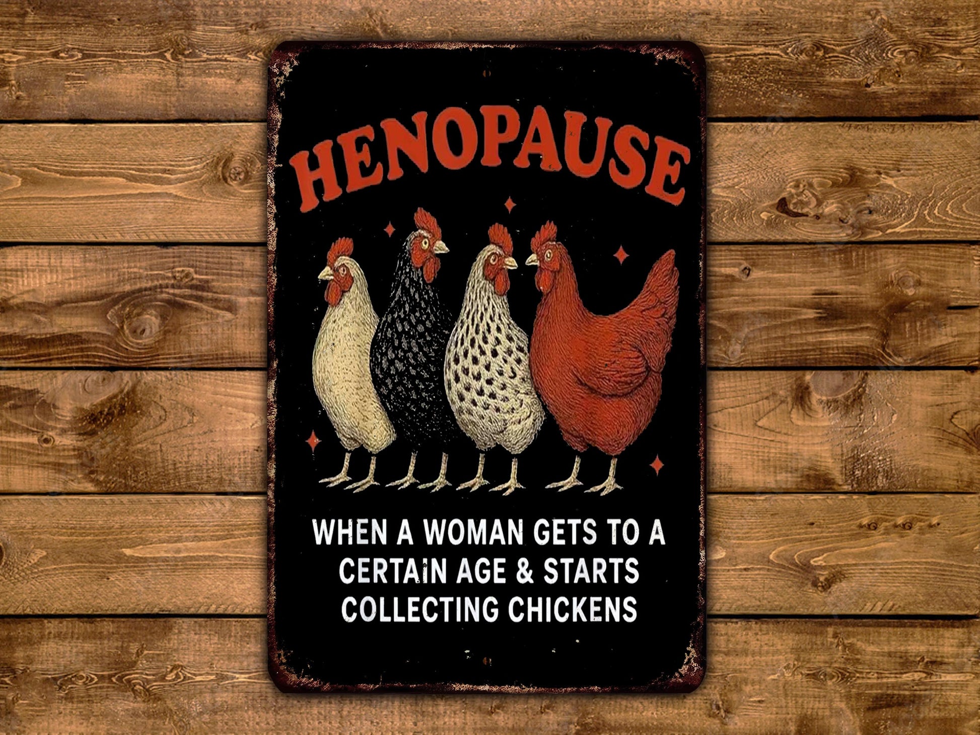 a sign with a humorous message about menopause, accompanied by four chickens in various colors.
