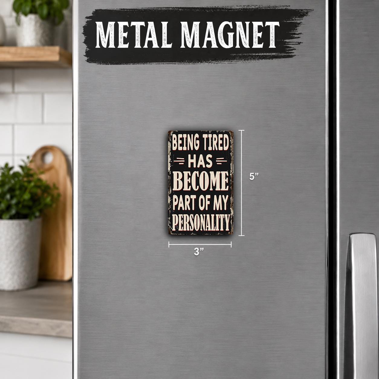 a small metal magnet with the text "Being Tired Has Become Part of My Personality" on it.