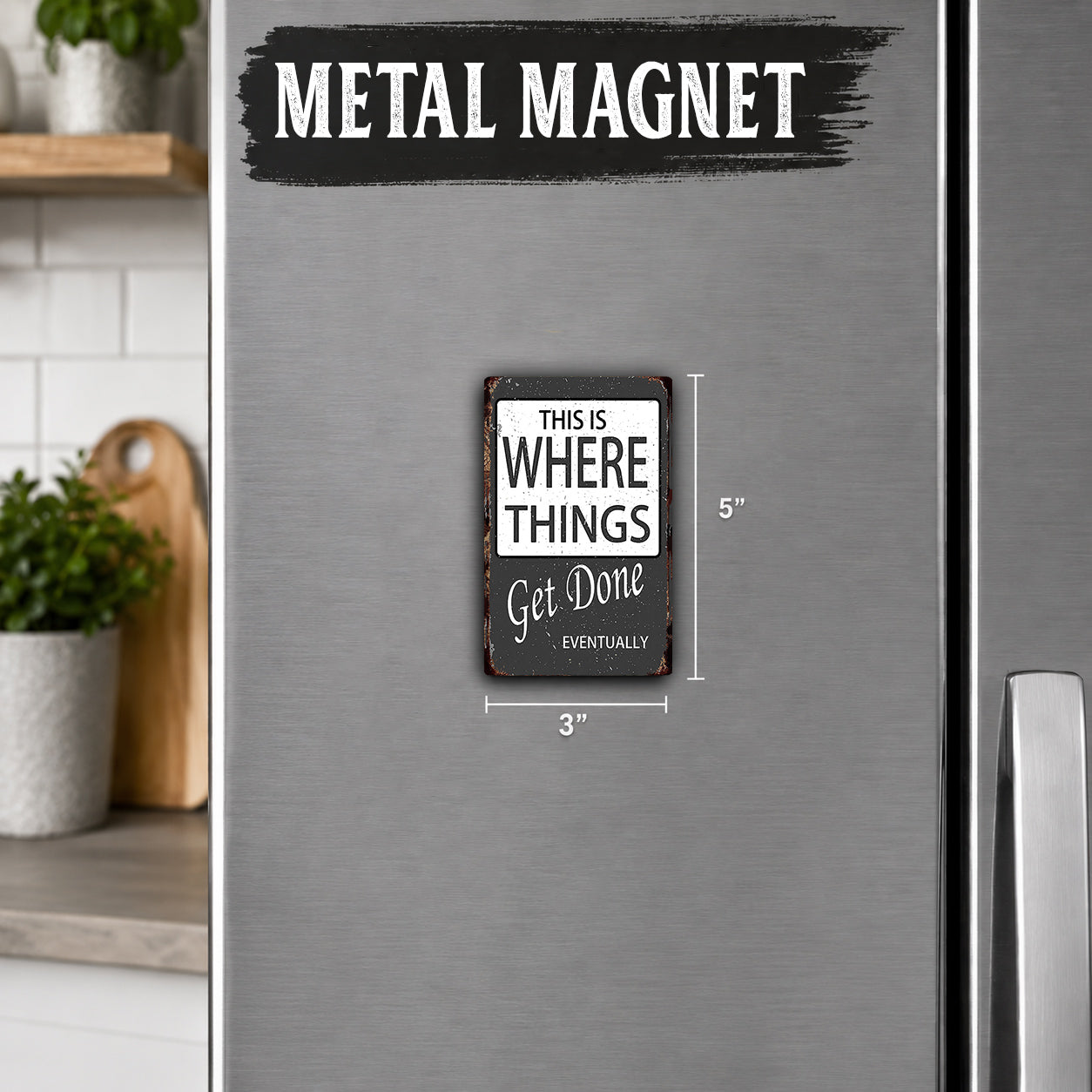 a metal refrigerator with a small black and white sign attached to it. The sign reads "This is where things get done" and is approximately 3 inches in size.